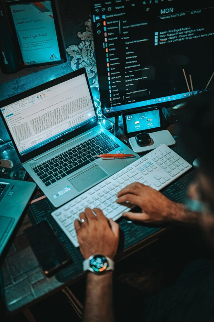 A man working and coding on a fancy setup